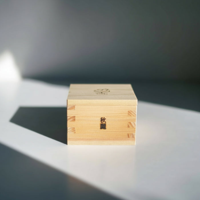 Wooden block with engraved text on a reflective surface