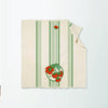 Beige towel with green stripes and red tomato design on a white background