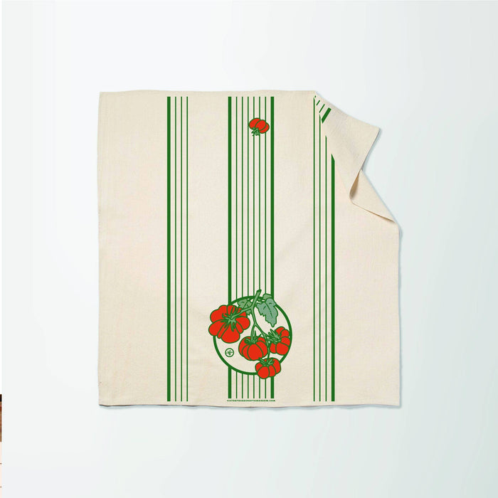 Beige towel with green stripes and red tomato design on a white background