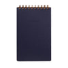 Dark blue notebook with gold spiral binding on a white background