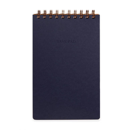 Dark blue notebook with gold spiral binding on a white background