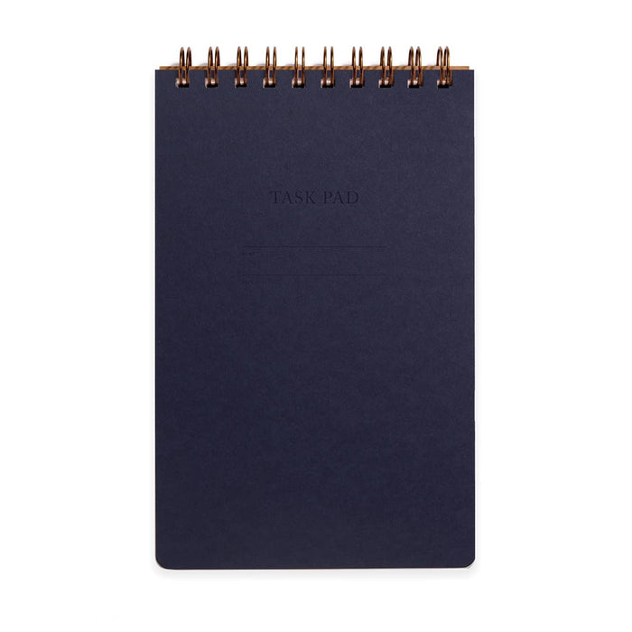 Dark blue notebook with gold spiral binding on a white background