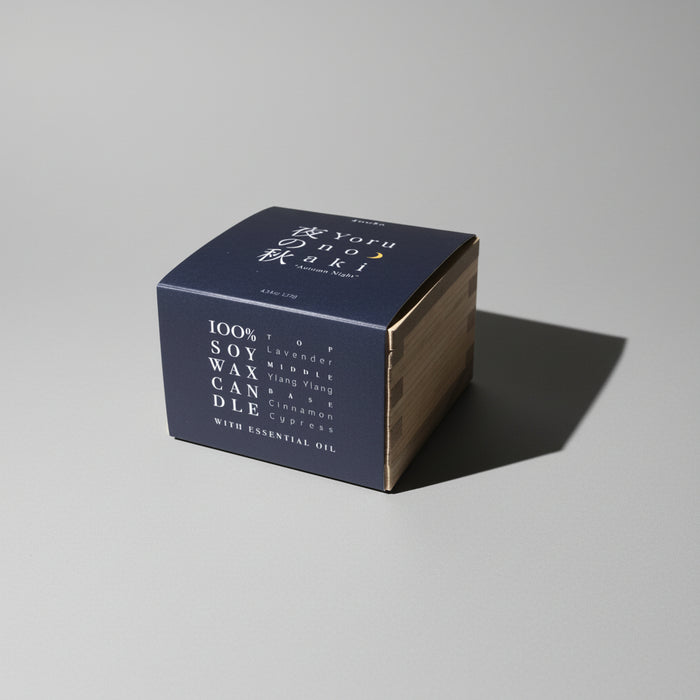 Square candle box with gold accents on a beige background