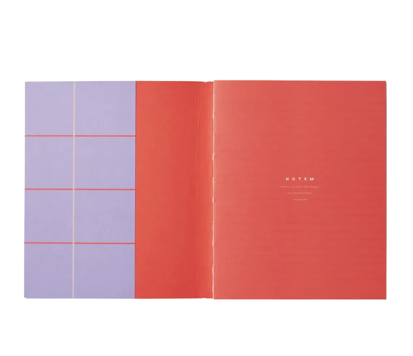 An open notebook with a coral red interior cover on the right and lavender pages with thin red grid lines on the left, shown against a white background.